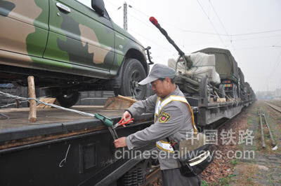 新乡站北运转车间货检员正在加固军运列车